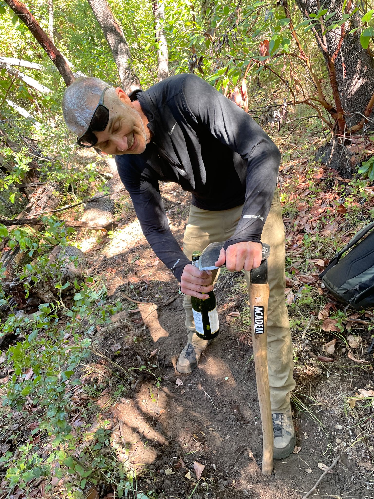 Opening the champagne with a hoe.