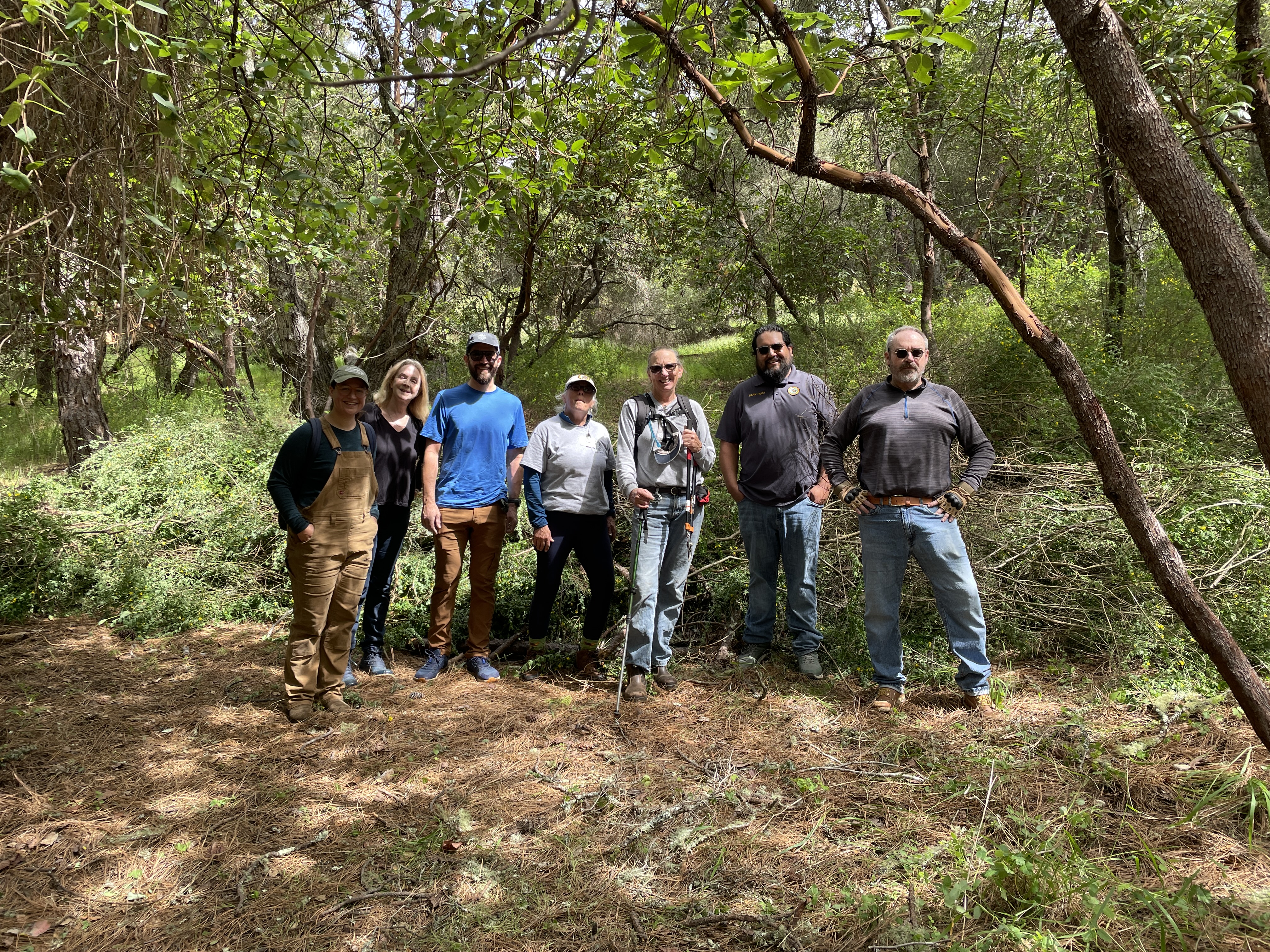 The crew in front of the broom pile at Quail Hollow.